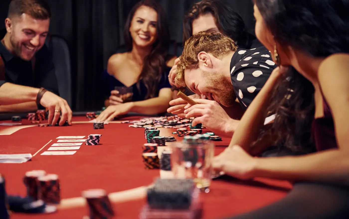 Stock photo: friends laughing while playing cards at a table