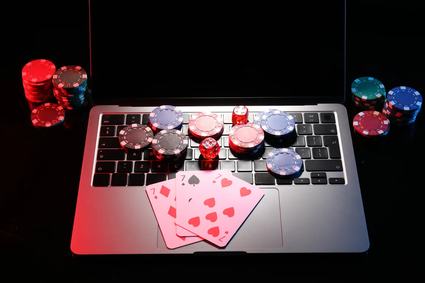 Stock photo: poker chips, dice and cards on a laptop keyboard